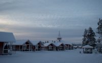 a small church in the middle of a snowy field